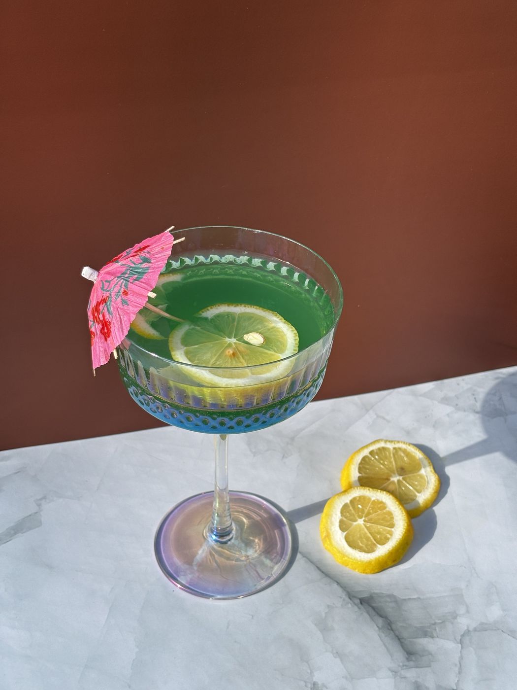 Cocktail with lemon slices on a marble table